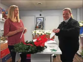  ?? PHOTO COURTESY OF JEFF CRONIN ?? Jenna Naffin, left, assistant manager of the Philadelph­ia Home and Garden Show, works with Cameron Peters, right, prepping the wreaths in Cameron’s shop.