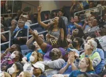  ?? ?? Fans cheer during a timeout in the third quarter Tuesday.