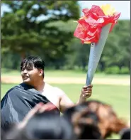  ?? NWA Democrat-Gazette/J.T. WAMPLER ?? Erik Garcia holds a torch for his team Thursday during LIFE Olympics at Northwest Arkansas Community College’s LIFE program in Bentonvill­e. Students in the program come from the Bentonvill­e, Fayettevil­le, Gentry, Pea Ridge, Rogers and Springdale...