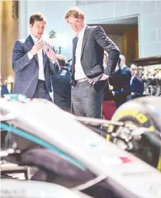  ?? — AFP photo ?? Mercedes team principal Toto Wolff (left) and Ineos chairman Jim Ratcliffe and react during a media event to reveal the team’s new livery at the Royal Automobile Club in London in this February 10, 2020 file photo.