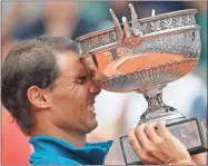  ??  ?? In this June 10, 2018, file photo, Spain’s Rafael Nadal reacts while holding the trophy after defeating Austria’s Dominic Thiem in the men’s finals of the French Open tennis tournament in Paris. Nadal, a French Open champion yet again a week past his 32nd birthday seems to stay forever young.