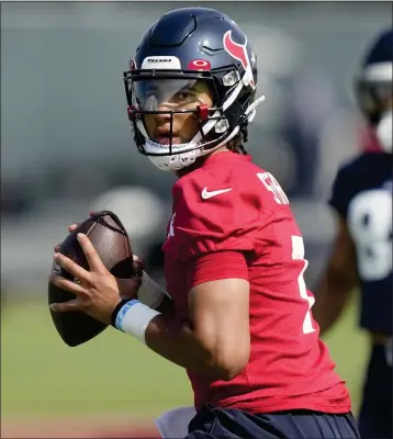  ?? DAVID J. PHILLIP — THE ASSOCIATED PRESS ?? Rookie C.J. Stroud, above, is competing against last year’s starter, Davis Mills, to be the Houston Texans’ starting QB.