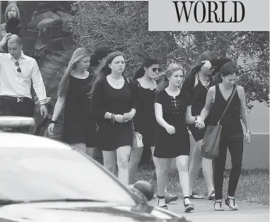  ?? JOEL AUERBACH / THE ASSOCIATED PRESS ?? Mourners leave the Church by the Glades in Coral Springs, Fla., on Thursday, where a funeral was held for football coach Aaron Feis, 37, who was among those killed at Marjory Stoneman Douglas High School on Valentine’s Day.