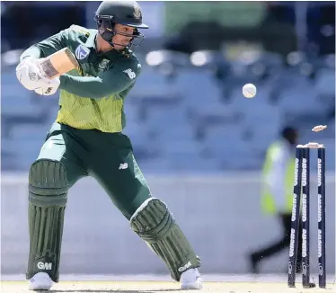  ?? Associated Press ?? SOUTH Africa’s Quinton de Kock chops his ball onto his stumps during yesterday’s limited overs match against Australia Prime Minister’s XI in Canberra. |