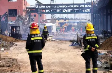  ??  ?? Firefighte­rs work on the rubble of a pesticide plant owned by Tianjiayi Chemical following an explosion in Xiangshui county, Yancheng, in this file photo. — Reuters photo