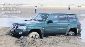  ??  ?? The car partly submerged in the mud on Ainsdale Beach