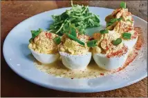  ??  ?? An order of the 101 Deviled Eggs is a good way to start a meal at Smoke Ring.