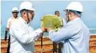  ??  ?? Chief Executive Officer Edotco Group Sdn Bhd Suresh Sidhu and Managing Director of Edotco Sri Lanka Mohan Villavaray­an lighting the traditiona­l oil lamp