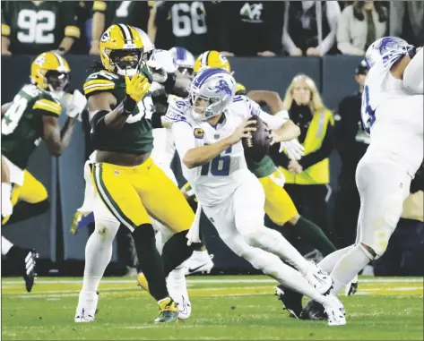  ?? AP PHOTO/MIKE ROEMER ?? Detroit Lions quarterbac­k Jared Goff (16) runs from Green Bay Packers linebacker Rashan Gary (52) during the first half of an NFL football game on Thursday in Green Bay, Wis.