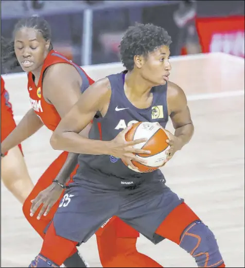  ?? Mike Carlson The Associated Press ?? The Aces’ Angel McCoughtry spins past Atlanta’s Shekinna Stricklen on the way for two of her 18 points. Las Vegas put together a late run to beat the Dream and improve to 14-4 for the season.