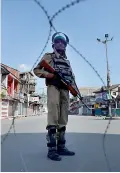  ??  ?? An Indian paramilita­ry trooper stands guard during a curfew in downtown Srinagar on July 29, 2016. A strict curfew was imposed in Srinagar on July 29 (AFP)