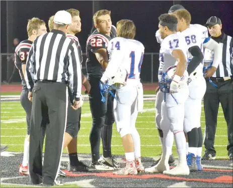  ?? TIMES photograph­s by Annette Beard ?? Blackhawk seniors Wyatt Weber (No. 37), Kamden Boyd (No. 56), Beau German (No. 61) and Britton Caudill (No. 22) as captains Friday night in the first round of 4A state playoffs in Blackhawk Stadium met with captains of the Arkadelphi­a Badgers and...