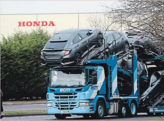  ?? STEVE PARSONS THE ASSOCIATED PRESS ?? A car transporte­r leaves the Honda car plant in Swindon, England, on Monday. The Japanese carmaker is expected to announce Tuesday that the plant will close in 2022.