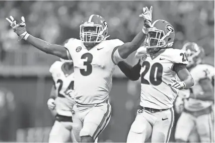  ?? BRETT DAVIS-USA TODAY SPORTS ?? Georgia Bulldogs linebacker Roquan Smith celebrates with teammates after recovering a fumble against the Auburn Tigers during the fourth quarter of the SEC Championsh­ip game.