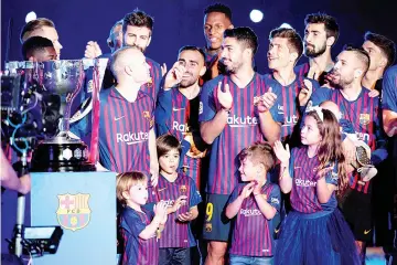  ??  ?? Barcelona’s Spanish midfielder Andres Iniesta (left) poses with teammates during a tribute at the end of the Spanish league football match between FC Barcelona and Real Sociedad at the Camp Nou stadium in Barcelona.