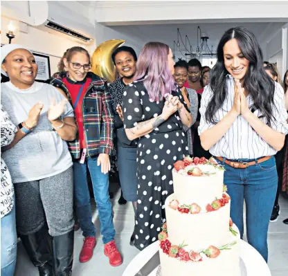  ??  ?? Empowered: the Duchess of Sussex with graduates of the Luminary Bakery on a visit to its second branch in Camden