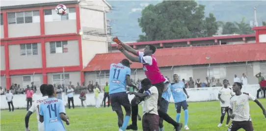  ?? (Photos: Paul Reid) ?? Herbert Morrison’s goalkeeper David Gordon punches the ball clear as he helps to preserve his team’s 1-0 lead against Holland High in their ISSA/WATA dacosta Cup Zone C game played in Montego Bay yesterday. This was Herbert Morrison’s second straight win.