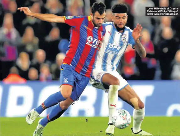  ??  ?? Luka Milivojevi­c of Crystal Palace and Philip Billing of Town tussle for possession