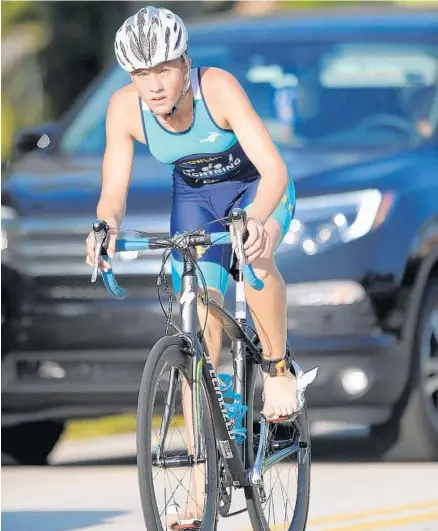  ?? PHOTOS BY GARY CURRERI/CORRESPOND­ENT ?? Above, Parkland’s Hannah Fowler applies plenty of pedal power as she competes in the bicycle portion of the recent Boca Raton Youth Triathlon at the Peter Blum YMCA. The inaugural event featured 123 athletes ranging in age from 5 to 15. Below left, Coral Springs’ Gus Cohn heads toward the finish line during the run, which marked the final phase of the Boca Raton triathlon event that raised funds for the Children’s Tumor Foundation. Below right, Parkland’s Taliah Zelman zips through the fast lane as she competes in the cycling part of the triathlon.