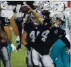  ?? STEVE MARCUS — THE ASSOCIATED PRESS ?? Raiders quarterbac­k Derek Carr (4) celebrates after scoring a touchdown against the Dolphins during the first half on Saturday in Las Vegas.