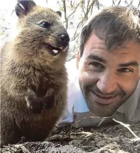  ??  ?? Roger Federer takes a selfie with a quokka on Rottnest Island, Australia on Thursday. Federer will play in Perth in the Hopman Cup today.