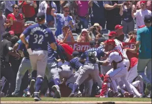  ?? (AP/Mark J. Terrill) ?? Several members of the Seattle Mariners and the Los Angeles Angels scuffle after the Mariners’ Jesse Winker was hit by a pitch during the second inning Sunday in Anaheim, Calif. The brawl resulted in the ejections of six players and both managers.