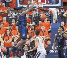  ?? ZACK WAJSGRAS/ASSOCIATED PRESS ?? Duke’s soaring Zion Williamson dunks while teammates and Virginia players look on during the second half of the No. 2 Blue Devils’ 81-71 victory Saturday at No. 3 Virginia.