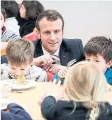  ?? LUDOVIC MARIN THE ASSOCIATED PRESS FILE PHOTO ?? French President Emmanuel Macron visits a school canteen in southweste­rn France in 2019.