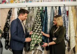  ??  ?? Behind the scenes: Product design manager, Yvonne Keal shows George Clarke the latest collection­s from Hillarys during his factory visit