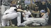  ?? Morry Gash Associated Press ?? THE DODGERS’ Clayton Kershaw is tagged out by Corbin Burnes while trying to score on wild pitch.