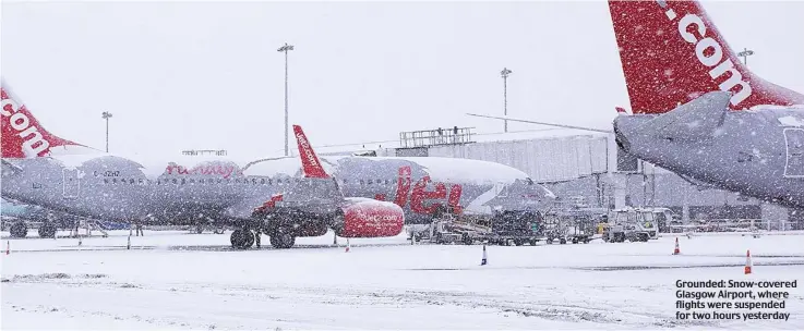  ??  ?? Grounded: Snow-covered Glasgow Airport, where flights were suspended for two hours yesterday