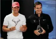  ?? VINCENT THIAN - THE ASSOCIATED PRESS ?? Spain’s Rafael Nadal, left, and Switzerlan­d’s Roger Federer hold their trophies as Internatio­nal Tennis Writers Associatio­n Ambassador­s of the Year at a news conference Saturday at the Australian Open tennis championsh­ips in Melbourne, Australia.