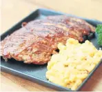  ??  ?? Baby back ribs with mac and cheese