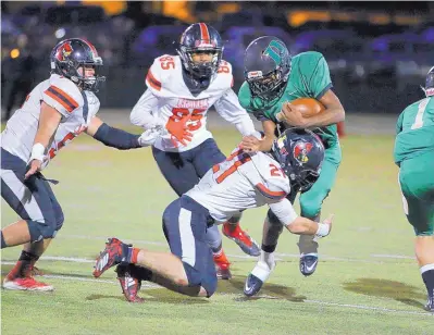  ?? COURTESY OF SHANNON STEPHEN ARAGON ?? After missing most of last season with an injury, West Las Vegas senior running back Darion Williams gained over 500 yards this season to help the Dons get back to the playoffs. Here, he’s tackled by Robertson’s Santiago Gonzales (21) and Julius Vaughn (85).