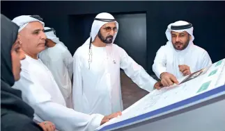  ?? Wam ?? Sheikh mohammed gets a briefing from rta officials about one of the future projects of the agency. during a visit on tuesday, he also endorsed a five-year plan for the constructi­on of roads in residentia­l districts. —