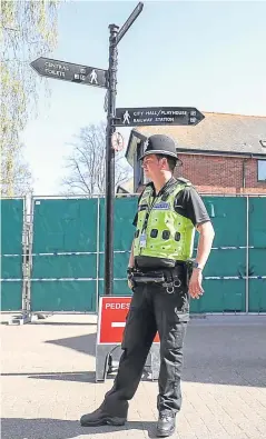  ?? PA. ?? Police at the Maltings shopping centre in Salisbury yesterday, as preparatio­ns begin to rid nine hot spots of the toxic after-effects of last month’s nerve agent attack.
