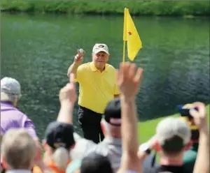  ?? DAVID CANNON, GETTY IMAGES ?? Patrons watch as Jack Nicklaus celebrates his hole-in-one on the fourth hole during the Par 3 Contest prior to the start of the 2015 Masters Tournament at Augusta National Golf Club.