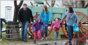  ?? RICK BOWMER — THE ASSOCIATED PRESS ?? Amy Coulter, right, and her husband Mark, second left, play with their children at the Place Heritage Park in Salt Lake City.