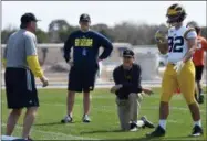  ?? TIFFANY TOMPKINS — THE BRADENTON HERALD VIA AP, FILE ?? In this file photo, Michigan’s head coach Jim Harbaugh, center right, watches defensive coordinato­r Don Brown, left, work with Cheyenn Robertson during NCAA college football practice in Bradenton, Fla. The two-a-day football practices that coaches once...