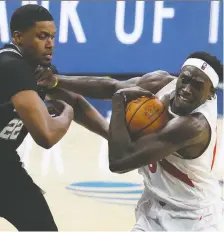  ?? GETTY IMAGES ?? Pascal Siakam, right, of the Toronto Raptors drives to the basket against Rudy Gay of the San Antonio Spurs Saturday.