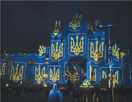  ?? The Canadian Press ?? The train station in Lviv, western Ukraine, is lit up by Swiss artist Gerry Hofstetter. Ukrainian officials in Lviv say there’s another way Canadians can support the embattled country’s economy and war effort, but it’s not for the faint of heart: pack your bags and come be a tourist.