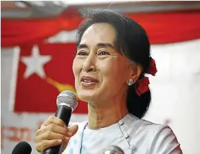  ??  ?? Renewed call: Suu Kyi speaking during a ceremony at her NLD party headquarte­rs in Yangon. — AP