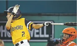  ?? TOM E. PUSKAR/ASSOCIATED PRESS ?? Ben Traxler of Peachtree City, Ga., follows through on his base hit that scored the winning run against Houston in Monday’s eliminatio­n game at the Little League World Series in South Williamspo­rt, Pa.