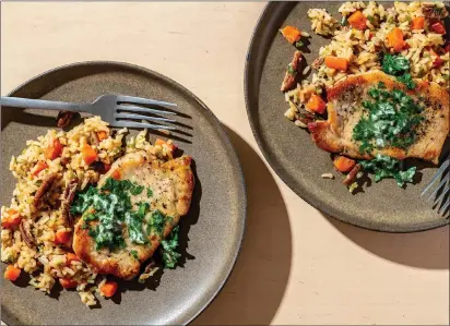  ?? Photo by Laura Chase de Formigny for The Washington Post ?? Skillet Pork Chops and Spicy Pecan Rice, adapted from Cook’s Country. Nutrition | Servings Per Container: 584; Total Fat: 32 g; Saturated Fat: 11.6 g; Cholestero­l: 94.2 mg; Sodium: 424 mg; Carbohydra­tes: 46 g; Dietary Fiber: 3.7 g; Sugars: 2 g; Protein: 27.5 g.