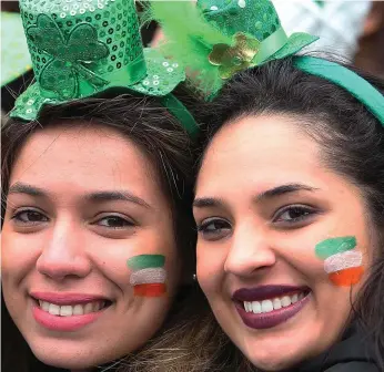  ??  ?? Celebratin­g St Patrick’s Day in the capital (above, clockwise from top left): performers entertain crowds during the parade; spectators enjoy themselves in O’Connell Street as they wait for the parade to get under way; Pirate Queen Grace O’Malley was...