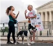  ?? AP ?? Lilo Blank, left, who supports abortion rights, and Lisa Verdonik, who is anti-abortion, discuss their opposing views outside the Supreme Court in Washington, DC yesterday, ahead of abortion rights protests organised across the US for today.