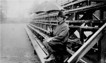  ??  ?? A spectator shelters from the rain as he hopes for play to resume at a cricket match in 1924. Photograph: Sharples/Getty Images