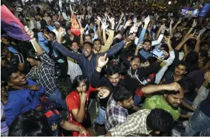  ?? — PTI ?? Fans celebrate in Bangalore after RCB beat Delhi Capitals in New Delhi on Sunday.
