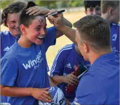  ??  ?? One young rugby fan makes sure everyone knows he got Josh van der Flier’s autograph at last week’s camp.