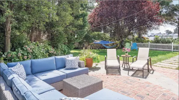  ?? Halstead Connecticu­t / Contribute­d photos ?? This cottage-style colonial offers water views . The backyard is filled with mature plantings and has a white picket fence.